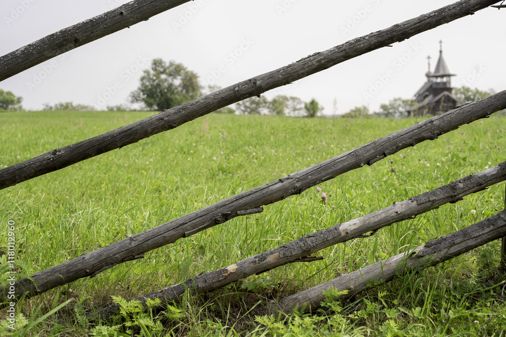 Fototapeta premium Church in Kizhi, through the old fence on the island of lake One
