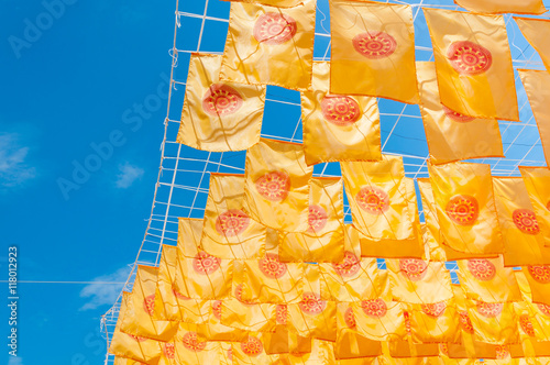 Thammachak flag yellow in temple (Wat Phan tao) on blue sky temple Northern Thailand