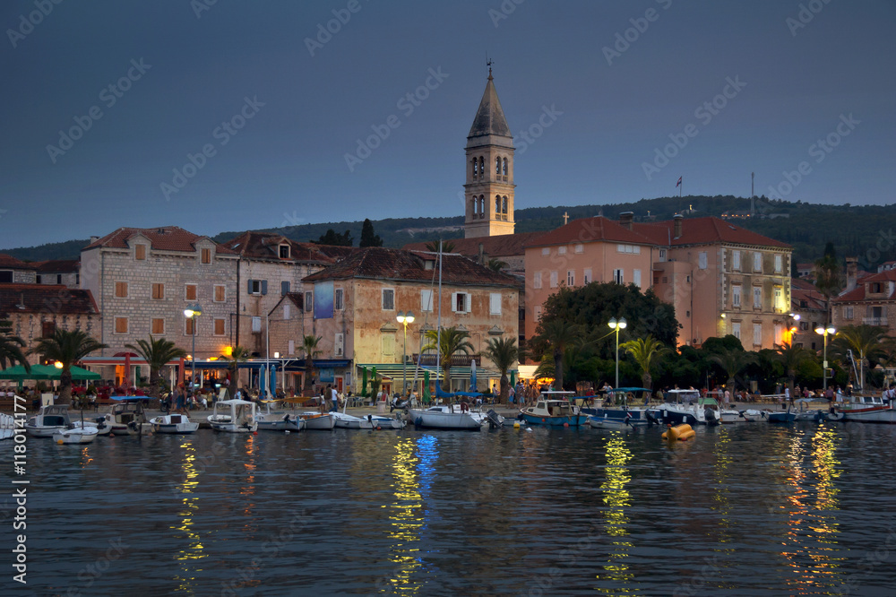 Houses and boats in port of town Supetar, night panorama