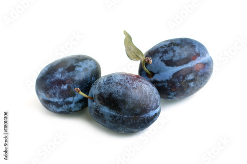 Ripe plums close-up on white background