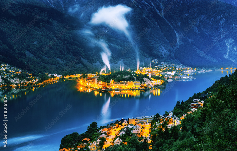 Ironworks at fjord in city Odda, Norway. Night landscape.