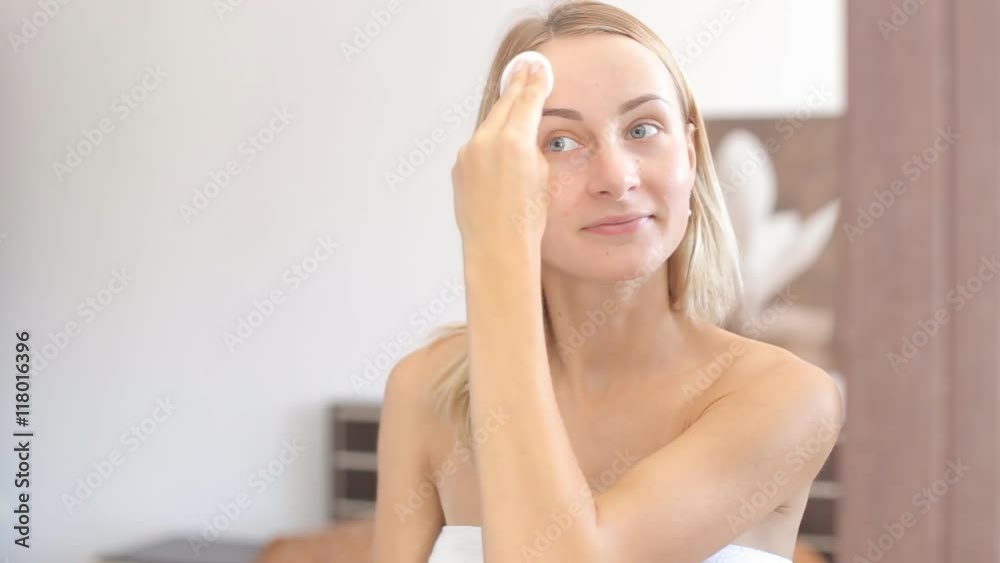 Young attractive woman cleaning her face Young attractive woman cleaning her face