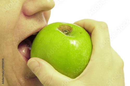 Woman bit a green apple isolated on the white