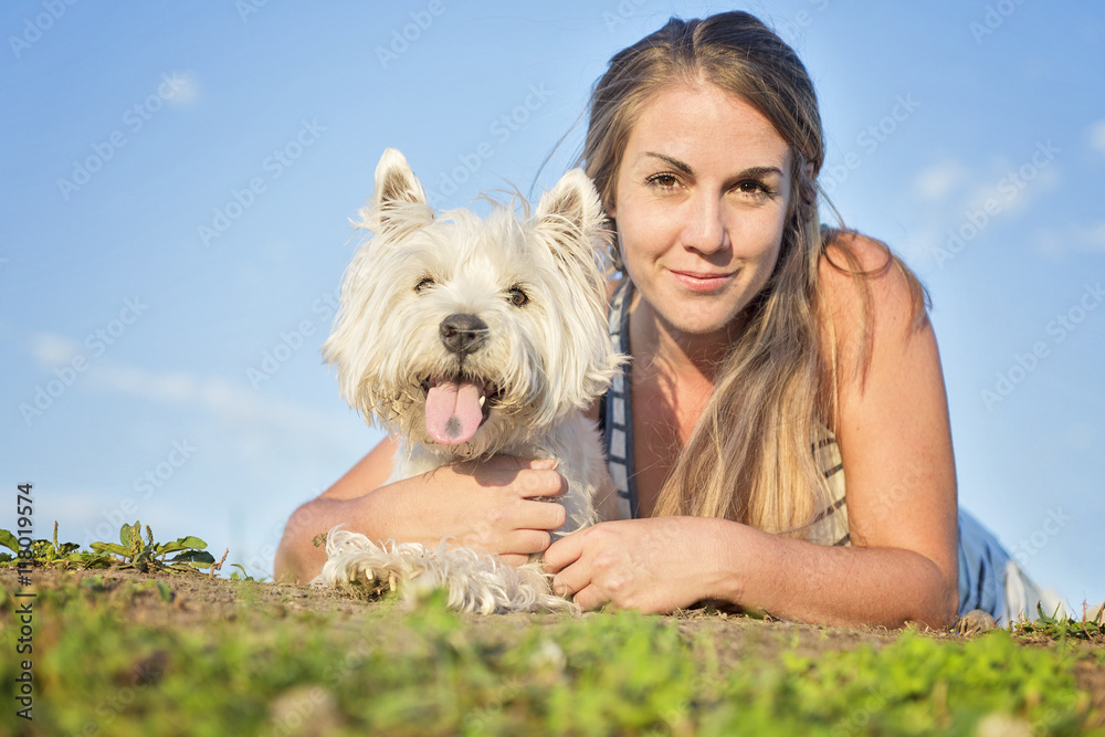 portrait of beautiful girl keeping pretty white West Highland dog outdoor portrait of beautiful girl keeping pretty white West Highland dog outdoor