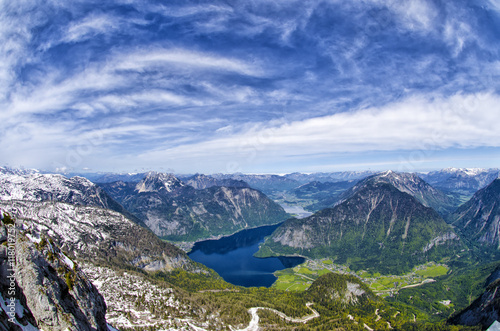 Panoramic aerial view of Alps mountains, snowy mountains peaks and Hallstattersee lake.