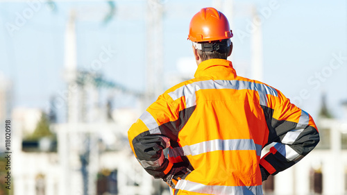 Service engineer standing in front of heat electropower station