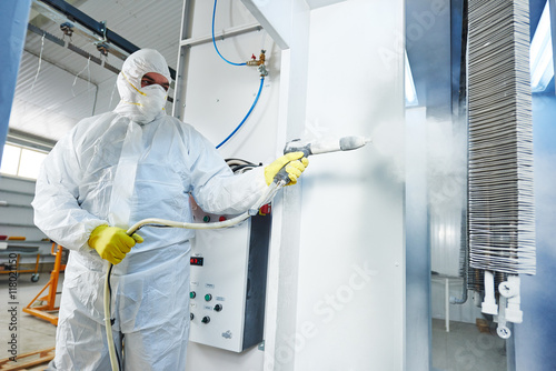 industrial metal coating. Man in protective suit, wearing a gas © Kadmy