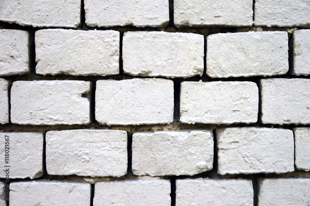 Old wall of bricks painted with white paint, close-up. Old wall of bricks painted with white paint, close-up.