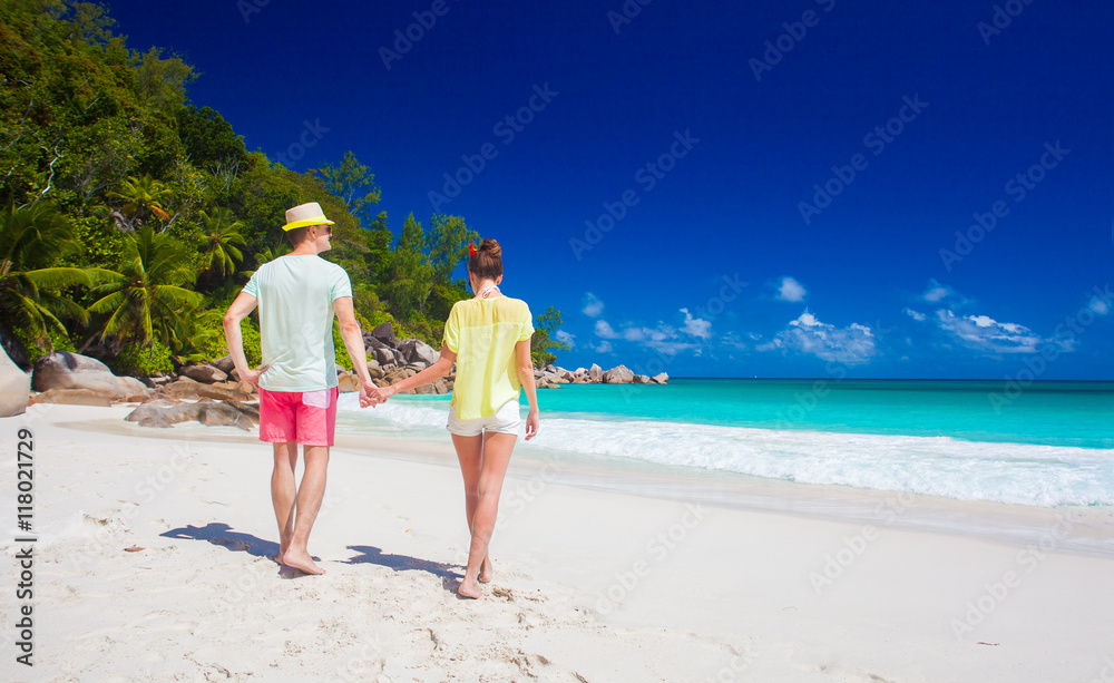 attractive couple enjoying sunny day at Anse Georgette beach. Praslin, Seychelles attractive couple enjoying sunny day at Anse Georgette beach. Praslin, Seychelles
