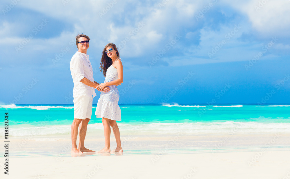 happy romantic young couple walking at the beach happy romantic young couple walking at the beach