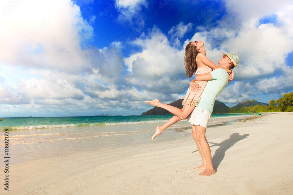 young couple in love having fun at tropical beach. Praslin, Seychelles young couple in love having fun at tropical beach. Praslin, Seychelles