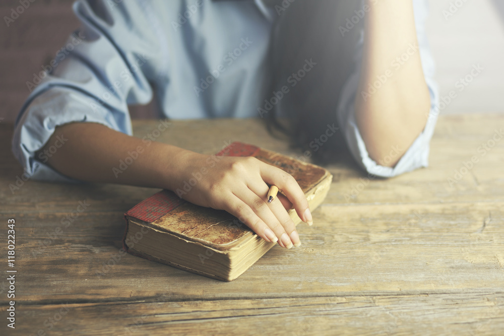 woman hand on book