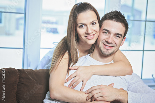 Happy couple at home relaxing in sofa