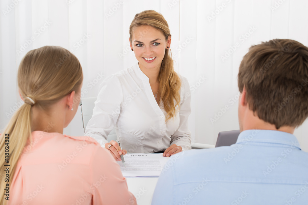Consultant Showing Document To Couple Consultant Showing Document To Couple