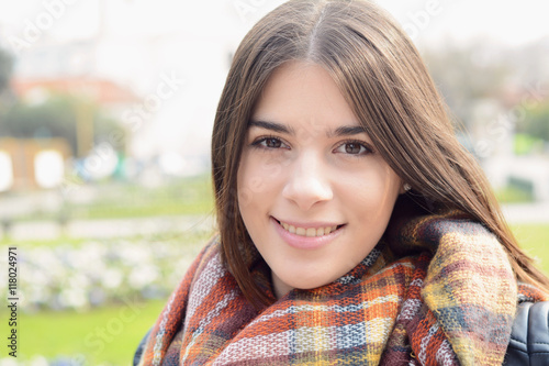 Close up of a young woman outdoors.