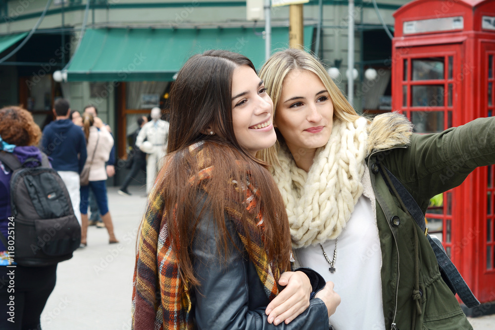 Two young tourists woman taking selfie.