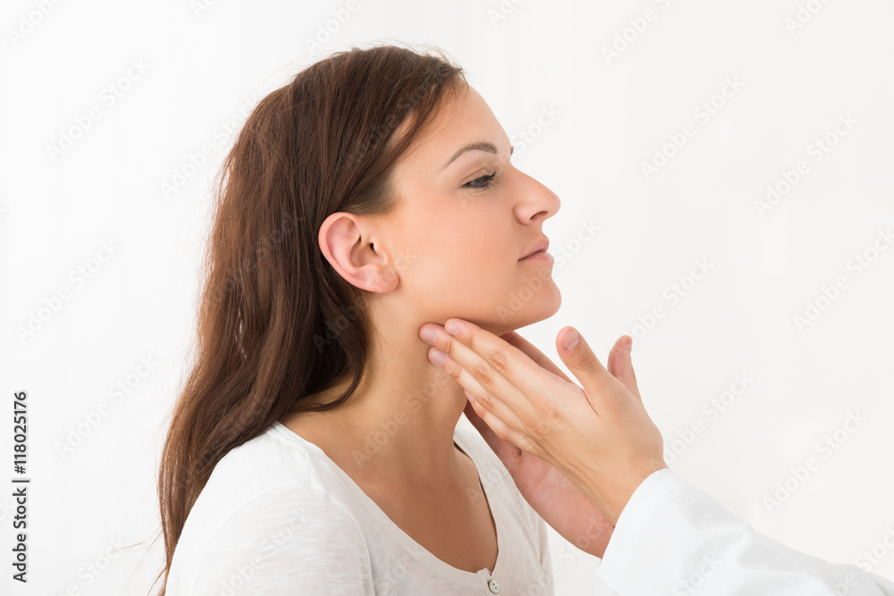 Doctor Checking Thyroid Of A Young Woman Doctor Checking Thyroid Of A Young Woman