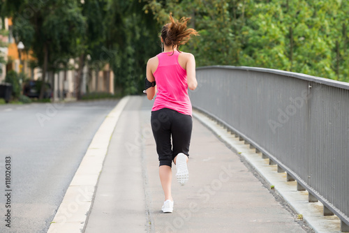 Fitness Woman Running On Sidewalk