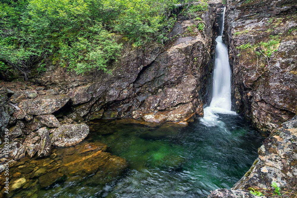 Small waterfall on the river Podkomarnaya in Khamar-Daban ridge