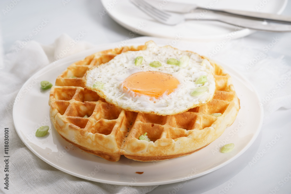 warm waffle with fried egg for breakfast. warm waffle with fried egg for breakfast.
