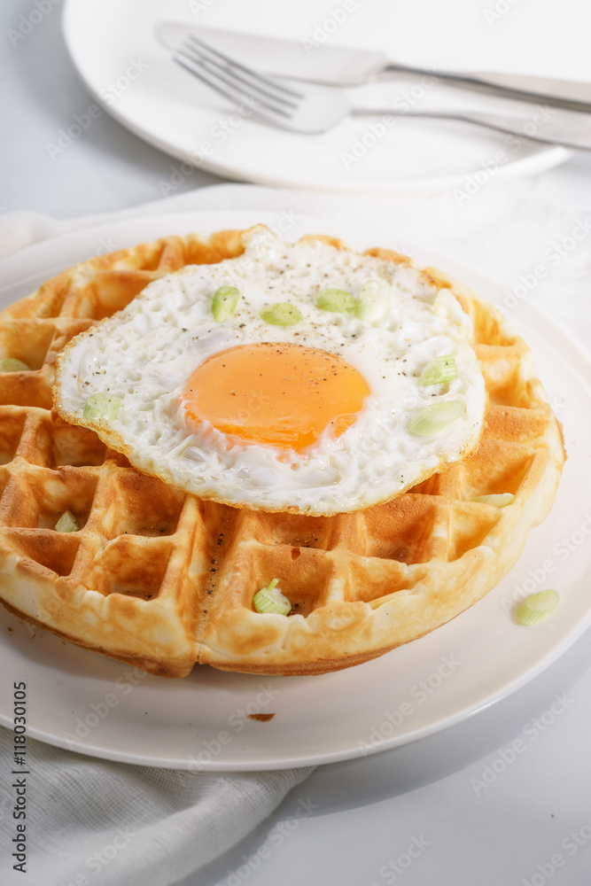 warm waffle with fried egg for breakfast. warm waffle with fried egg for breakfast.