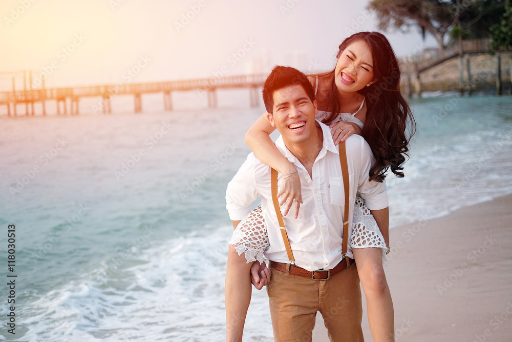 Sweet young couple on the wood bridge in sunset Sweet young couple on the wood bridge in sunset