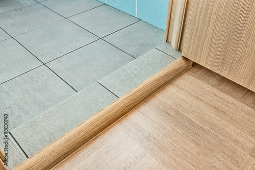 Doorstep before entrance to the bathroom with grey floor