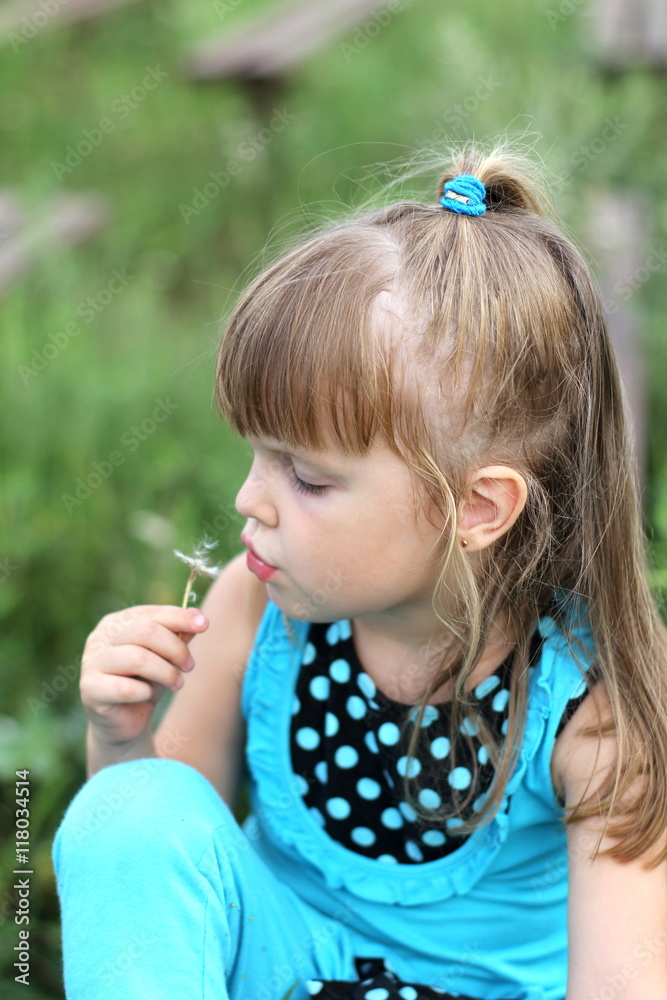 little girl with long hair playing on grass in summer little girl with long hair playing on grass in summer