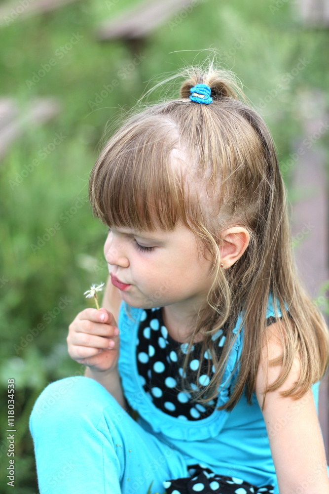 little girl with long hair playing on grass in summer little girl with long hair playing on grass in summer