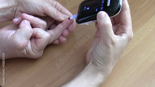 Woman performs home glucometer