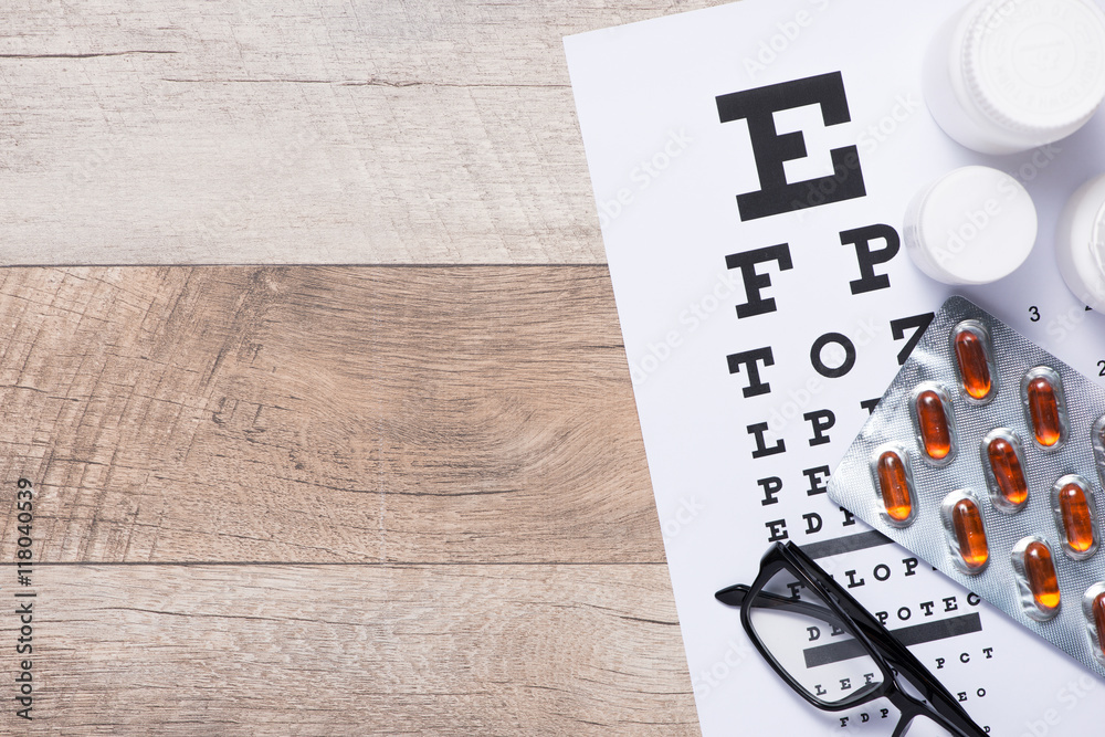Fototapeta premium Healthy eyes. Eye chart and medicine