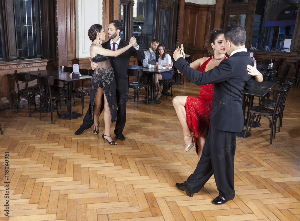 Dancers Performing Tango On Hardwood Floor While Couple Dating