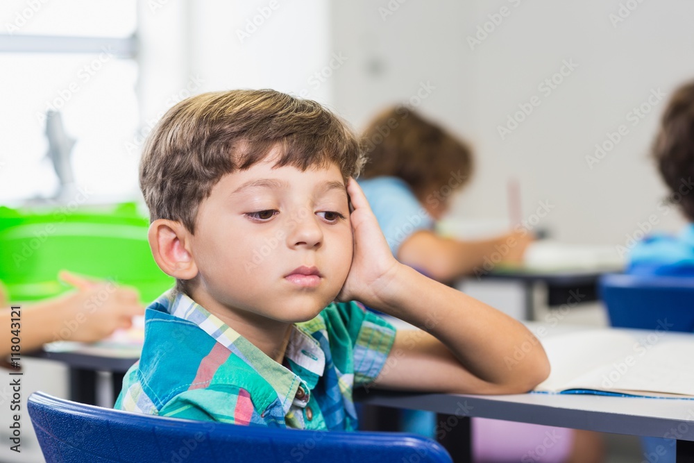 Thoughtful boy looking away while studying Thoughtful boy looking away while studying