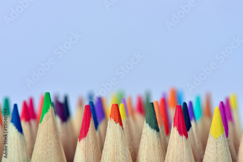 Mixed colored pencils isolated on light blue background