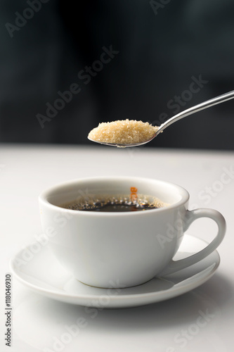 pouring brown sugar in white cup