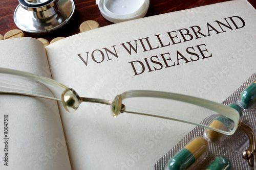 Book with diagnosis Von Willebrand disease and pills. Medical concept. photo