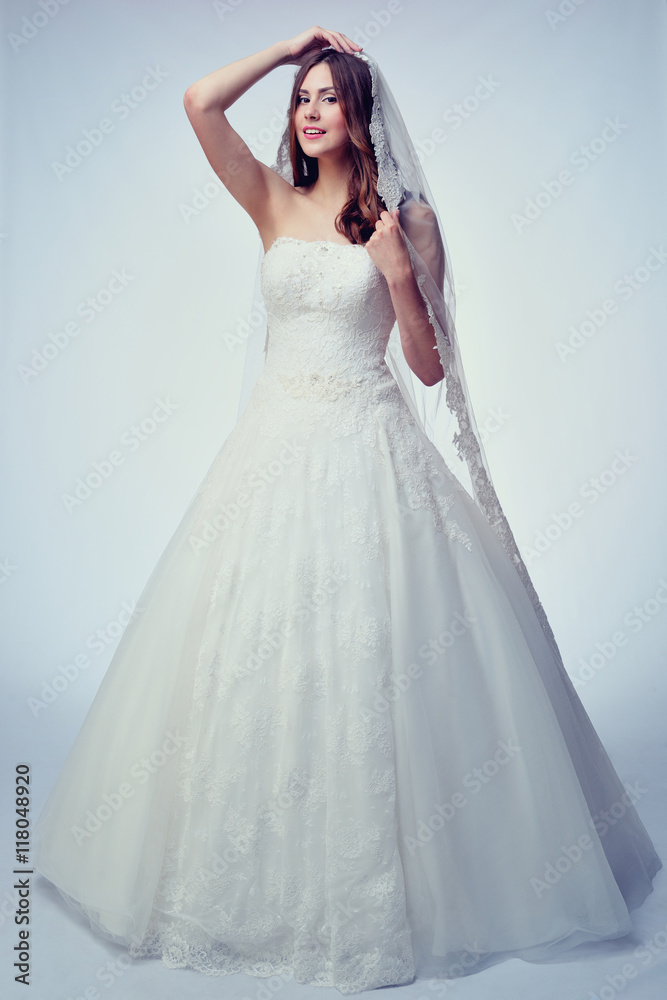 Beauty woman with wedding hairstyle and makeup. Bride fashion. Woman in white dress.