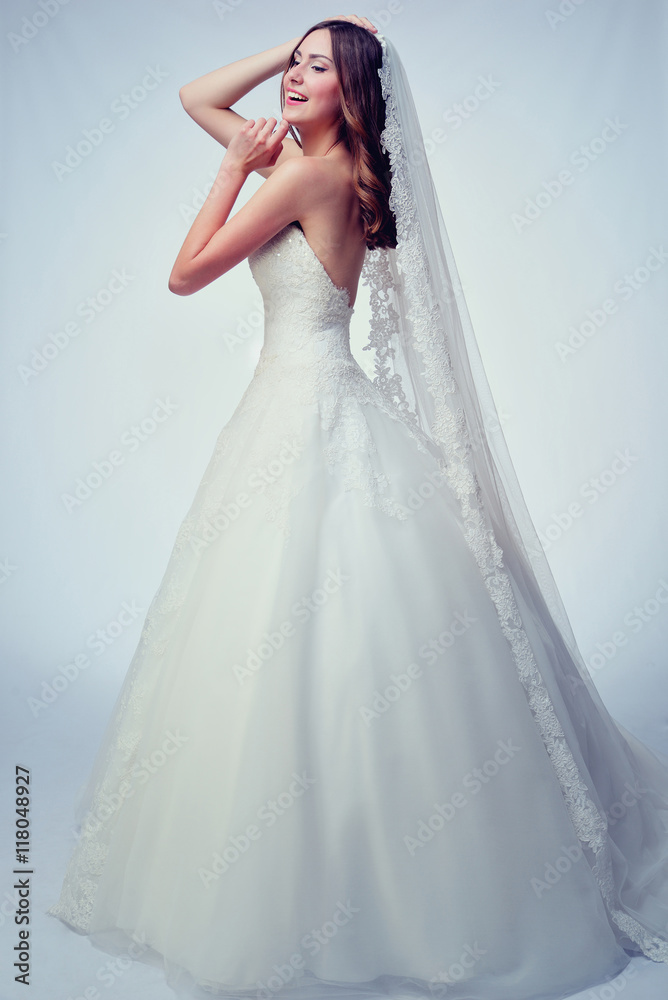 Beauty woman with wedding hairstyle and makeup. Bride fashion. Woman in white dress.