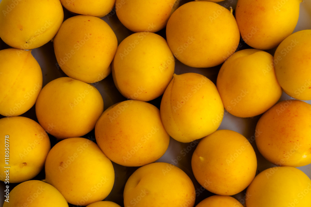 Fresh yellow apricot background texture.