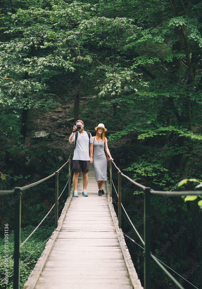 Hipster couple hiking on the background of a nature