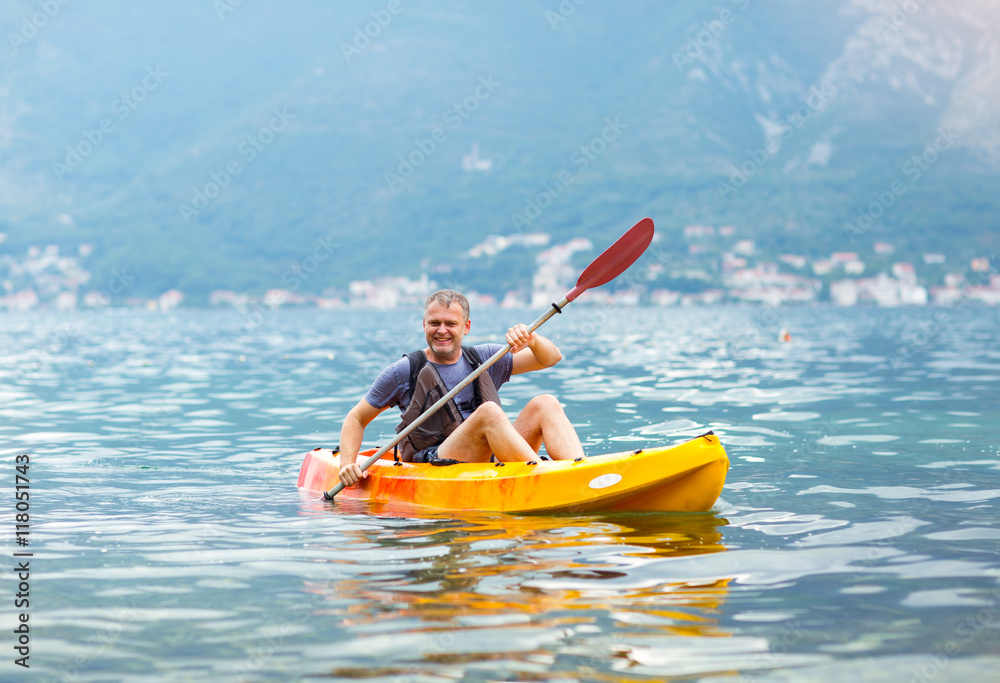 Mature man kayaking on the sea