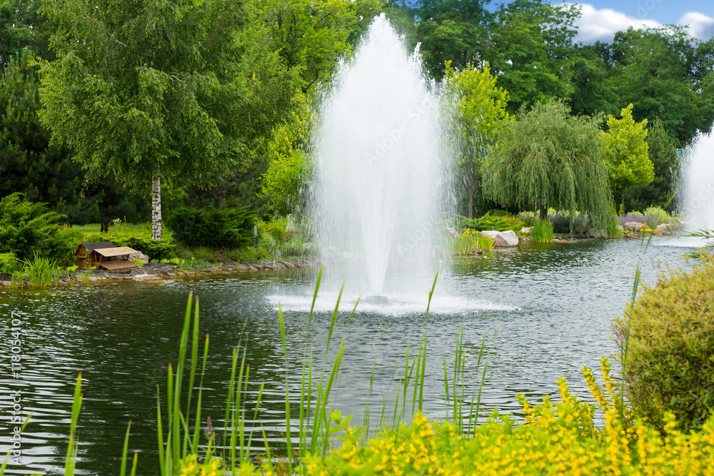 Working fountains on the human-made lake in the park