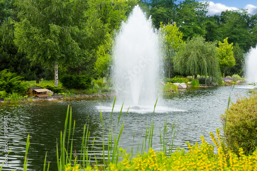 Working fountains on the human-made lake in the park