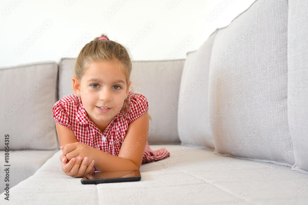 Adorable girl learning with her tablet device