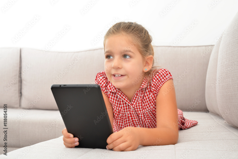 Adorable girl learning with her tablet device Adorable girl learning with her tablet device