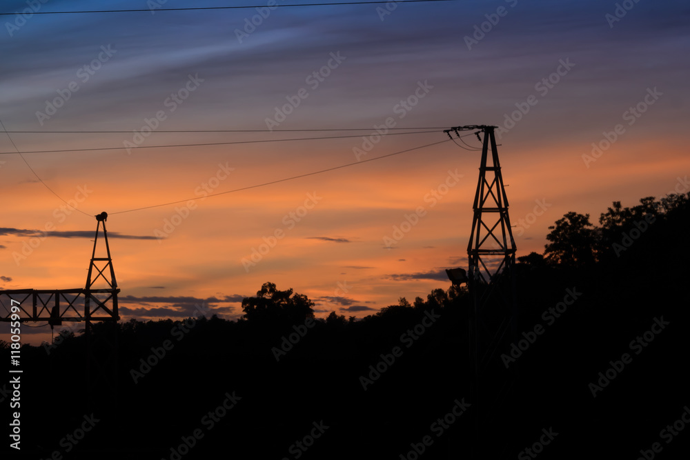 Silhouette of Electric Power Lines and High power transmission line at sunset