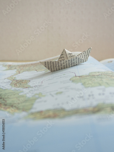 Paper boat on a map book