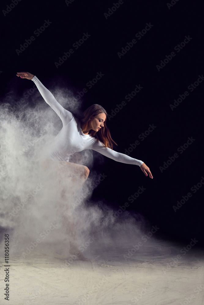 Ballerina dancing with flour on a black background. Dancer in a white bathing suit dancing gracefully with flour. Powder Photo Shoot. Ballerina dancing with flour on a black background. Dancer in a white bathing suit dancing gracefully with flour. Powder Photo Shoot.