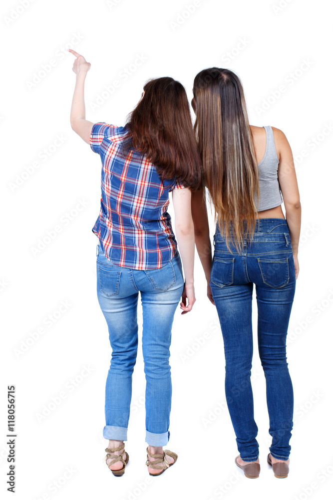 Back view of two pointing young girl. Rear view people collection. backside  view of person. beautiful woman friends showing gesture. Rear view.  Isolated over white background. Two young girls in Stock Photo
