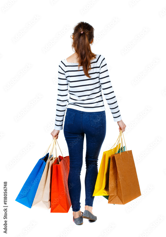 back view of going  woman  with shopping bags . beautiful girl in motion.  backside view of person.  Rear view people collection. Isolated over white background. Girl in a striped sweater went off
